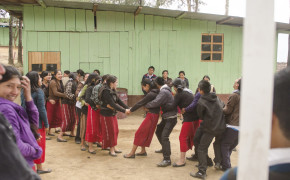 The second building of ENBI High School. The kids are on break and playing a tug of war game just using their hands.